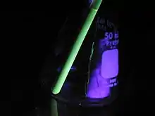 A sample of polythiophenes in an NMR tube. Due to the high degree of conjugation, the sample fluoresces under ultraviolet light.