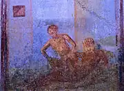 A female is sitting on a male's lap, lowering herself on his penis. Wall painting from Pompeii, 1st Century