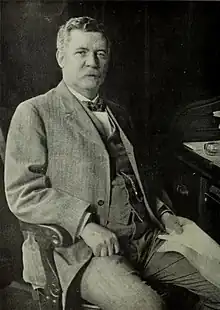 Black & white photograph of a man - Morgan - sitting.