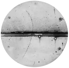 Curved arc shows a cloud chamber trajectory of a positron.