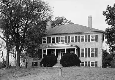 Photo of a brick mansion surrounded by trees