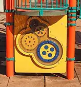 Detail of play structure showing gear motif.