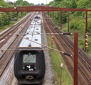 Overhead lines in Denmark near Roskilde. For aesthetic reasons, the support structure is constructed from hollow COR-TEN steel masts.