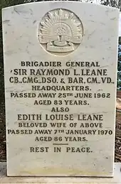 a colour photograph of a white marble gravestone