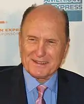 Headshot of Robert Duvall smiling and looking to the bottom left of the camera, in 2007