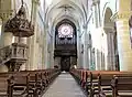 Inside view towards the pipe organ and the rose window