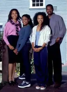 An image of an African-American family standing outside a house