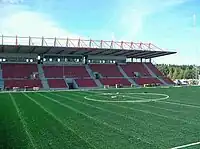 Empty stadium stands, seen from across the pitch