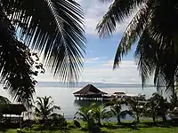 San Pedro Bay shore facing northeastward towards Cancabato Bay and the San Juanico Strait beyond, backgrounded by Samar island on the horizon.