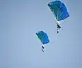 Members of the "BLUE WINGS" parachuting group from Romania descending to the harbour of Kavala (2013 AirSea Show)