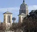 The building is seen in the background to the right, behind the San Fernando Cathedral.