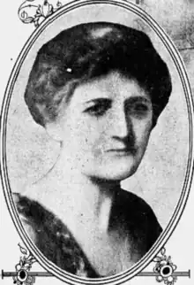 A middle-aged white woman, not smiling, hair in an updo, photograph in an oval frame; from a 1925 newspaper.