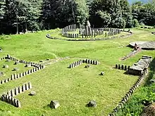 Remains of circular buildings in a glade