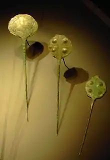 Ornamental pins, found in Switzerland, date to the first half of the 2nd millennium BC; their circular heads are incised with crosses