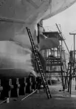 Ship in the floating dry dock of Bremer Vulkan shipyard during an inspection of its propeller and rudder