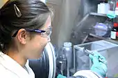 A scientist in UCL Chemical Engineering uses a glovebox to manipulate a sample