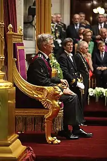 King Philippe I of Belgium seated on the throne inside the senate during his swearing-in ceremony