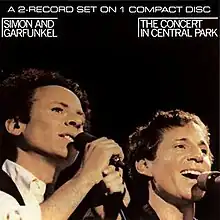 A man with curly hair, Art Garfunkel (left), and a shorter, smiling man, Paul Simon (right).