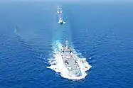 Four ships in a row moving toward the camera.