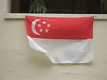 A home displaying the national flag underneath their window