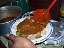 Sliced siomay poured with peanut sauce.