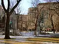 Interior of the square, with two monuments visible, Tribute to Laurier in foreground and Boer War Memorial behind with Dominion Square Building in background