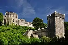 the castle on a hill on the left, the church below on the right