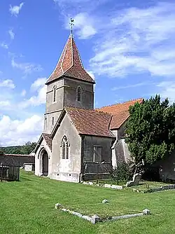 Stone church with red tiled roofs.