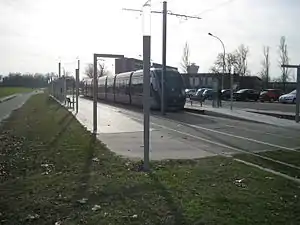 Double-track railway line in street with shelters on side platforms