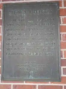 brown plaque on red brick wall reading "In this old capitol on April 25, 1861, Senator Douglas delivered his 'Protect the Flag' speech, one of the most heroic and effective speeches in the English language. His plea helped save our country and was the culmination of his great career."