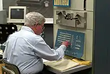 Steve Russell sitting at a PDP-1 mainframe