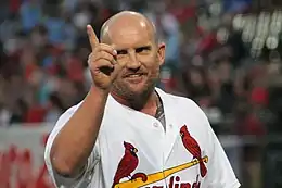 A man in a white baseball jersey