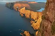 The ship went between the four skerries and the steep sea cliff of Lopranseiði, just below the mountain (under the bird).