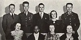 Group photograph of four men and one woman on the back row and four seated women in front. Harris, the only Black woman, is in the front row 2nd seat from the left.