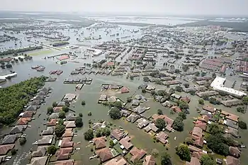 Aerial view of a large inundated area with roads submerged under floodwaters.