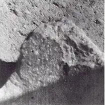 Spotted fragment about 1.5 meters from Surveyor 7 camera. Bright spots have indistinct boundaries and vary from less than 1 mm to about 8 mm across.