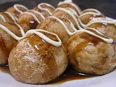 Takoyaki served with Japanese Worcester sauce and mayonnaise