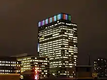 Target tower lit at night in a rainbow at the top