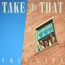 The three band members looking out of a window with the text 'TAKE THAT' above them and 'THIS LIFE' beneath