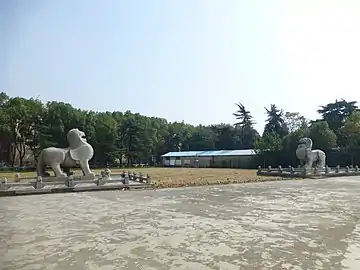 A very large pair of winged, stone pixiu guarding a tomb in China