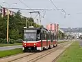 A tram on the separate tramway track of SNP Avenue