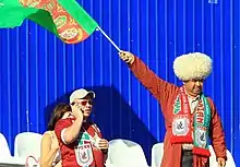 Turkmen football fan with a papakha (right)