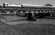 The Helsinki–Turku line was not electrified until 1994. In the years prior, Dr13 locomotives with blue-grey express trains were a regular sight, here seen on the steel bridge over the Paimionjoki river, pulled by Dr13 no. 2343, which is one of the two preserved locomotives.