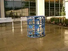 A defunct turnstile on paving outside a supermarket