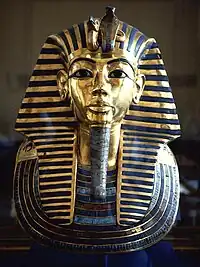 Tutankhamun's mask - King Tutankhamun, son of Akhenaten, returned to the former capitol and restored the cult of Amun to its former influence; although he died young and was not considered significant in his own time, the 1922 discovery of his KV62 intact tomb by Howard Carter, made him relevant as a symbol of ancient Egypt to the modern world