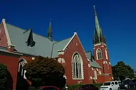 A color photograph of a brick building, a church