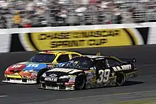 Ryan Newman edges his car past Kyle Busch during the race