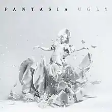 An image of a shattered white ceramic girl with the title of the single and the artist's name on the top.