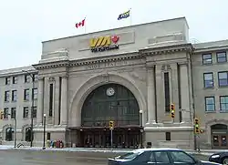 Large grey stone building with large ornamental archway entrance