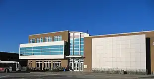 Long, modern building under a blue sky